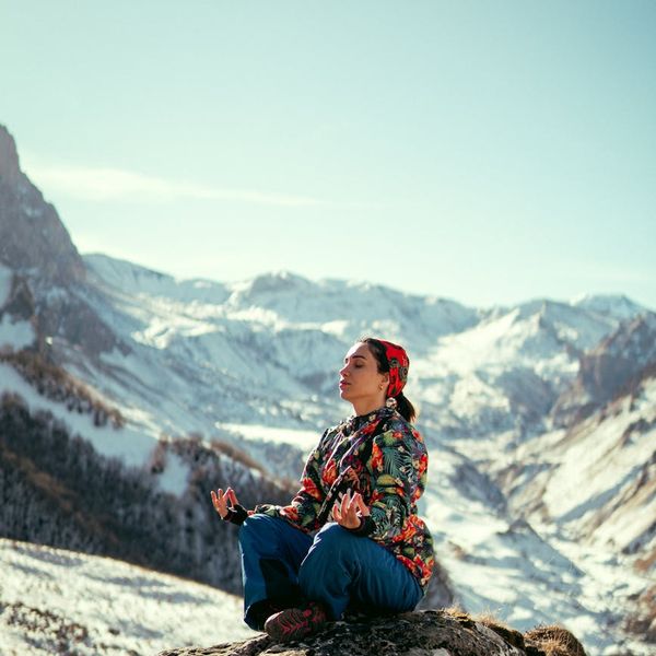 Woman meditating peacefully in a bright, airy space.